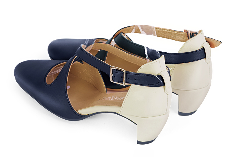 Navy blue and off white women's open side shoes, with crossed straps. Round toe. Low comma heels. Rear view - Florence KOOIJMAN